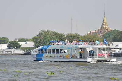 The Chao Phraya Tourist Boat floating past the Grand Palace