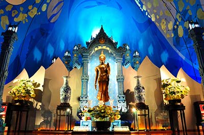 A golden Buddha statue in the Erawan Museum