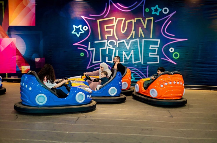 Driving bumper cars at Froggy’s Amusement Park