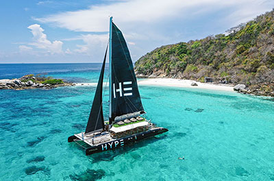 The Hype catamaran in a bay with crystal clear waters